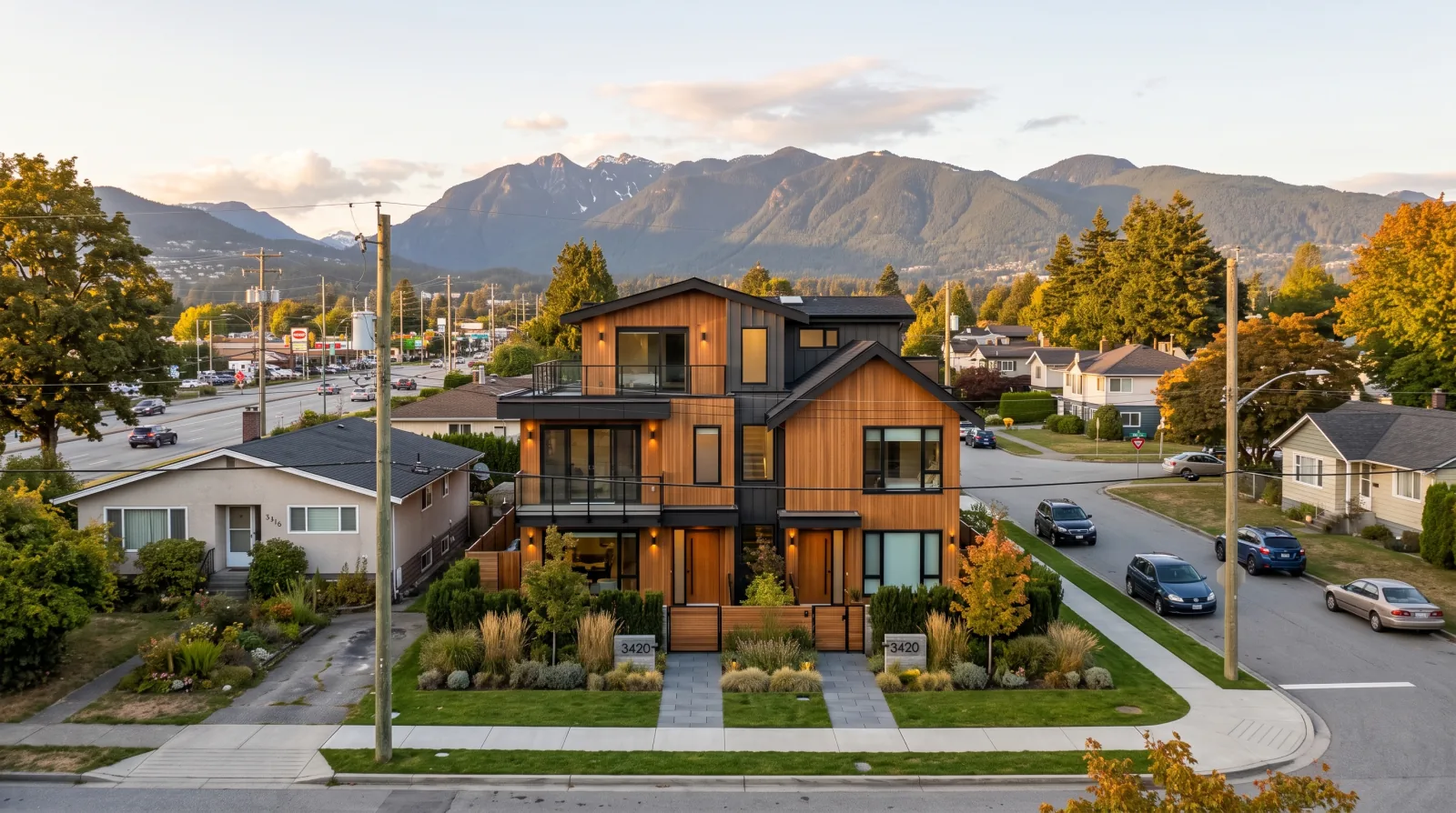 A modern low-rise multiplex replacing a post-war rancher on a flat Norgate street in the District of North Vancouver, with the North Shore mountains behind