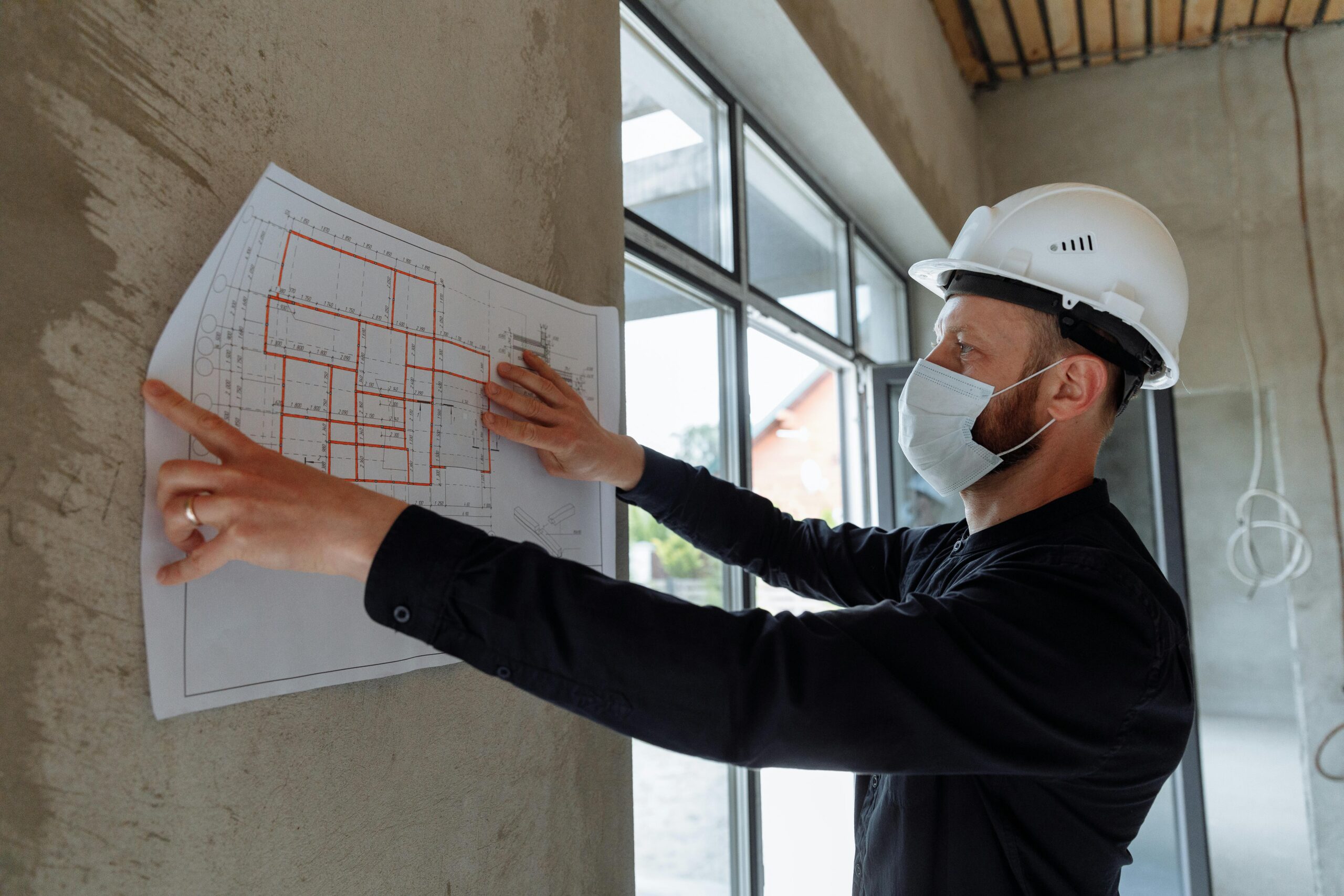 Vancouver building permit construction manager reviewing floor plans on site