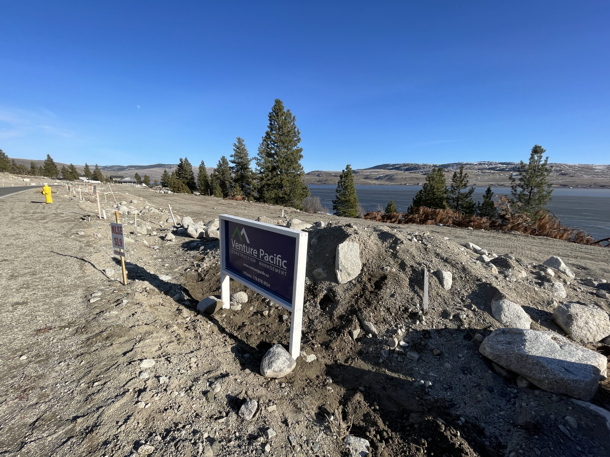 Custom home lot site review with Venture Pacific signage on a property under evaluation